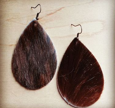 Leather teardrop earrings in brown hair on hide